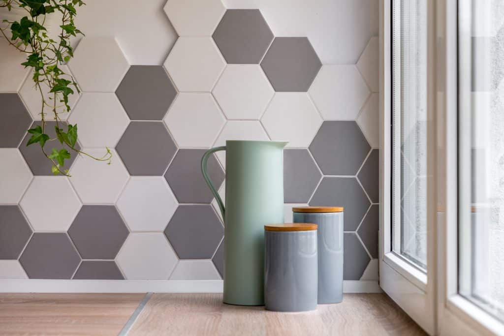 Home interior with hexagonal tiles, wooden countertop and decorative conatiners