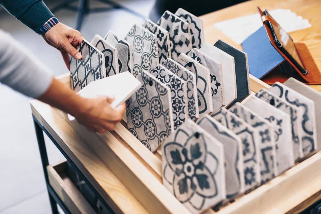 Middle age couple choosing new ceramic tiles for their home bathroom